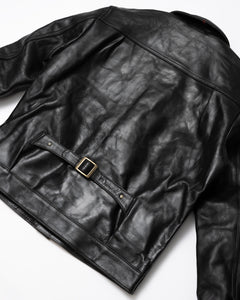 Front View of the Hardline Jacket: A front view of the Hardline Jacket by Master Supply Co., showcasing the premium vegetable-tanned cowhide leather with a rich patina and pleated front design.