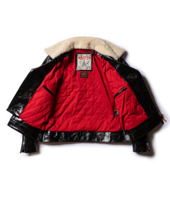 Interior view of the Dawson black leather jacket, showing the bright red quilted lining and the cream shearling collar.